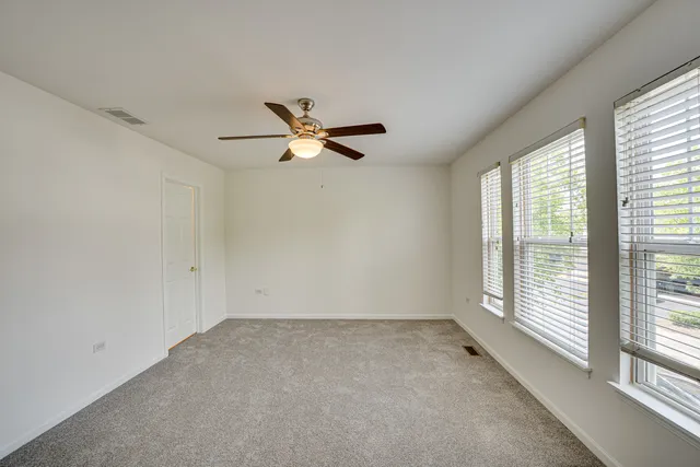 a view of a livingroom with a ceiling fan and window
