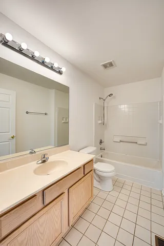 a bathroom with a double vanity sink mirror and toilet