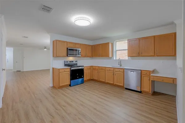 a kitchen with stainless steel appliances granite countertop a stove a sink and a refrigerator