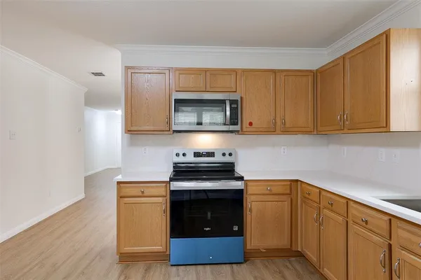 a kitchen with granite countertop wood cabinets and stainless steel appliances