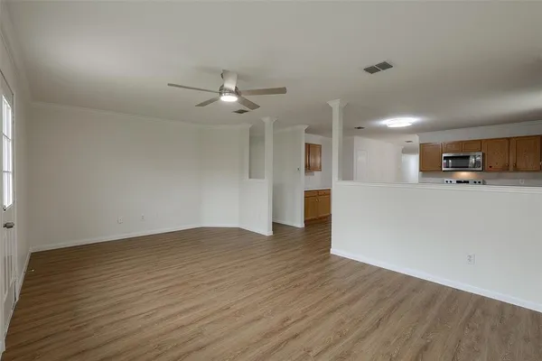 a view of a kitchen with a sink and a refrigerator