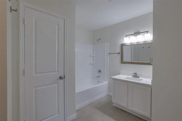 a bathroom with a sink a shower and a mirror