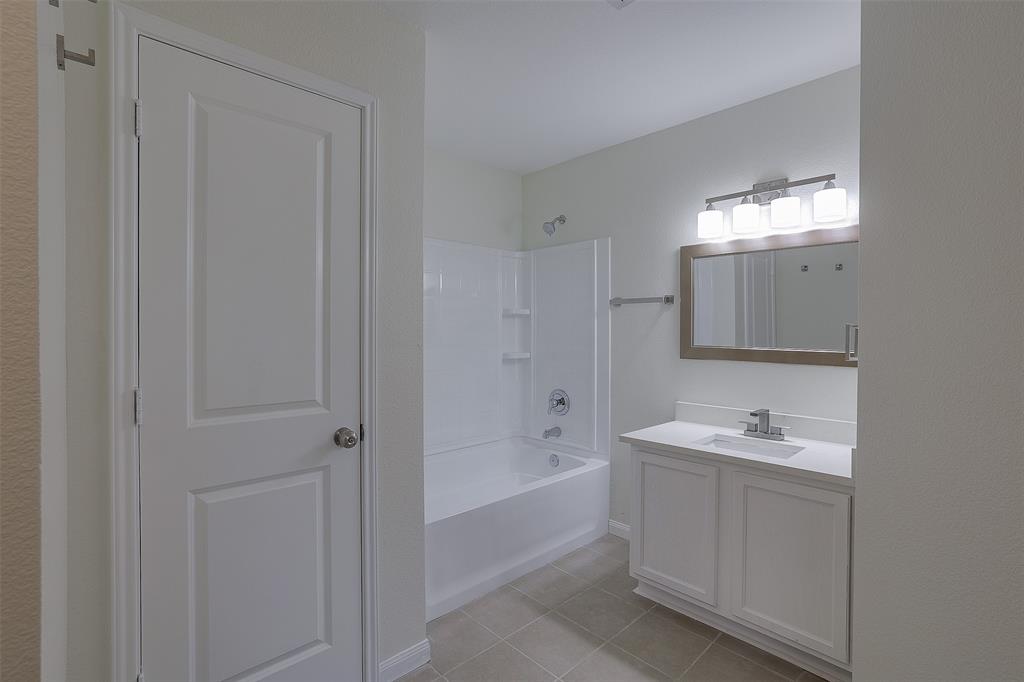 8422 Seven Hills Road Arlington, TX 76002 - Photo 19 of 28 a bathroom with a sink a shower and a mirror