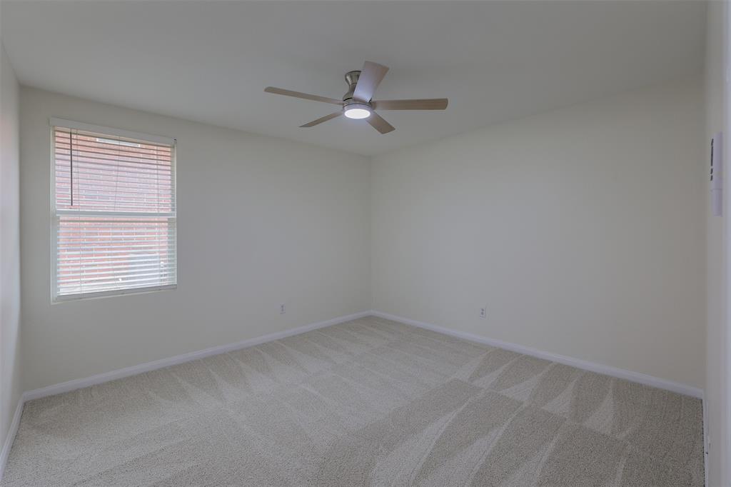8422 Seven Hills Road Arlington, TX 76002 - Photo 21 of 28 an empty room with a window and ceiling fan