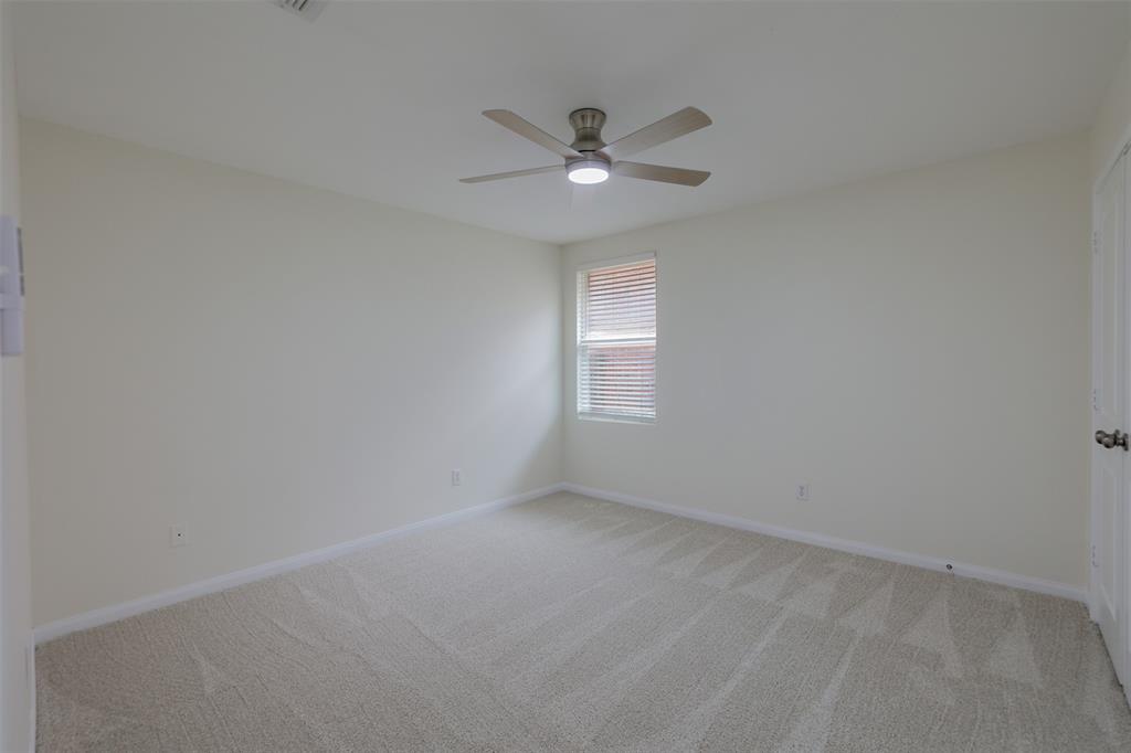 8422 Seven Hills Road Arlington, TX 76002 - Photo 23 of 28 an empty room with a window and a fan