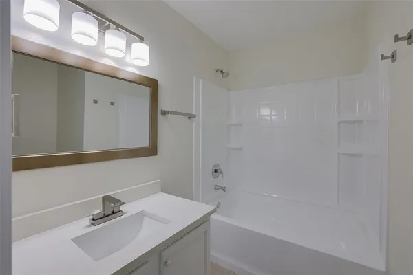 a bathroom with a sink a shower and a mirror