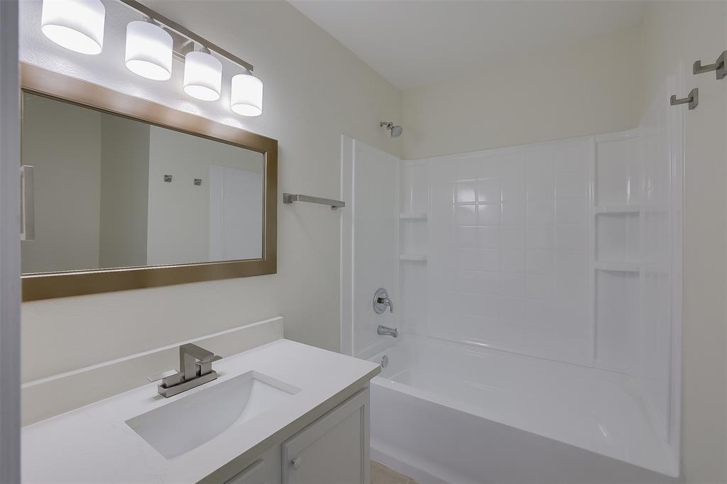 8422 Seven Hills Road Arlington, TX 76002 - Photo 25 of 28 a bathroom with a sink a shower and a mirror