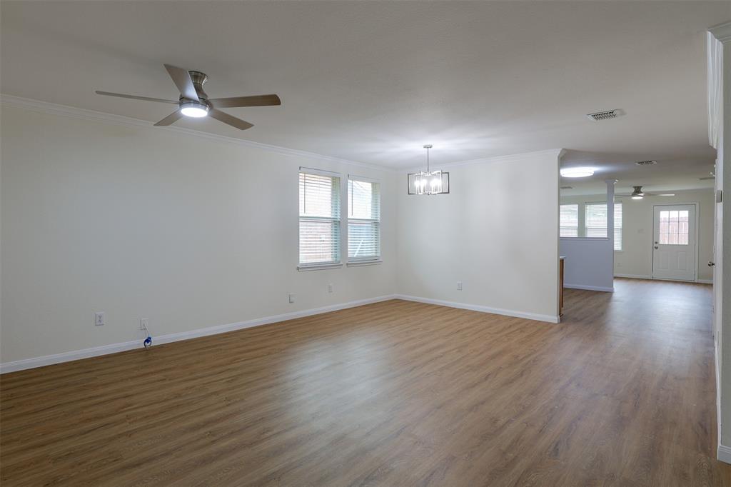8422 Seven Hills Road Arlington, TX 76002 - Photo 7 of 28 an empty room with wooden floor and windows