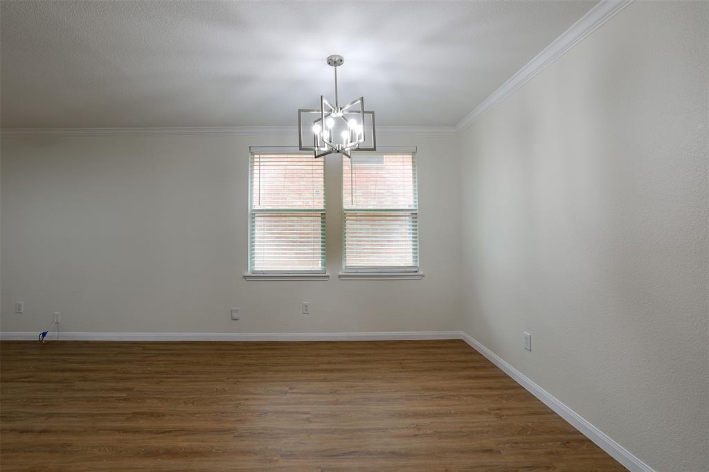 8422 Seven Hills Road Arlington, TX 76002 - Photo 9 of 28 a view of a room with wooden floor chandelier and window
