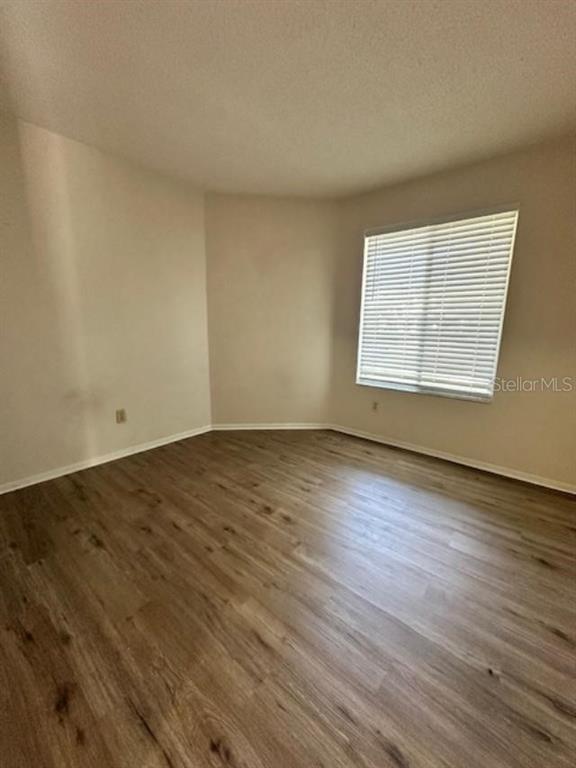 3153 Ginger Circle Orlando, FL 32826 - Photo 11 of 16 an empty room with wooden floor and windows