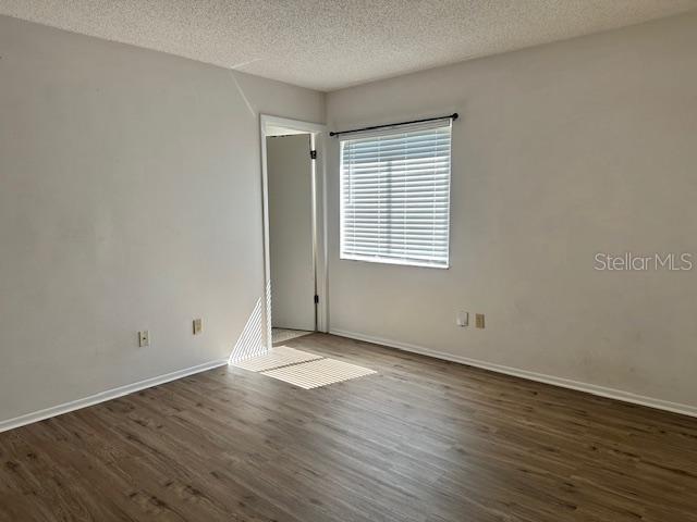 3153 Ginger Circle Orlando, FL 32826 - Photo 8 of 16 an empty room with wooden floor and windows