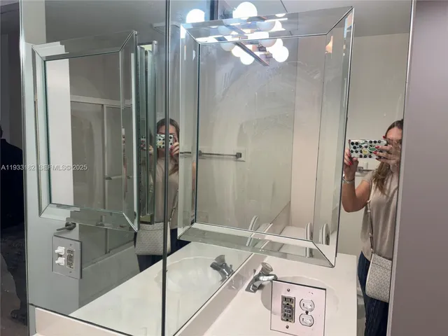 a bathroom with a tub sink and mirror