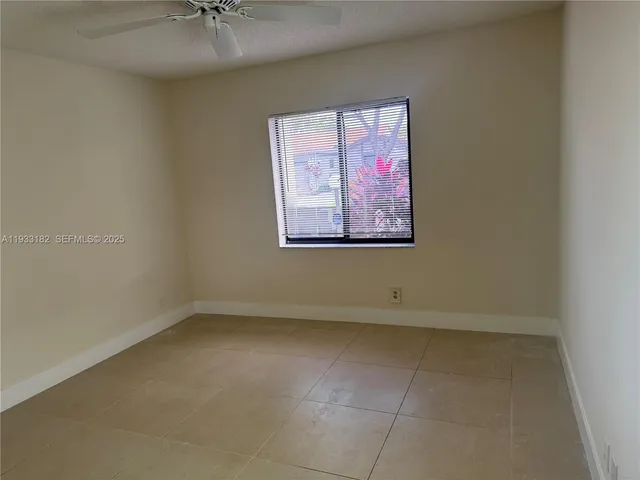 an empty room with a fan