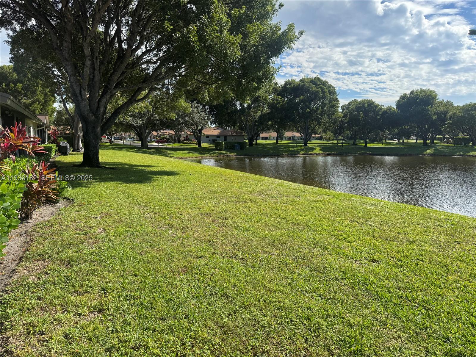 8200 Whispering Palm Drive, Unit F Boca Raton, FL 33496 - Photo 2 of 19 a view of lake with houses