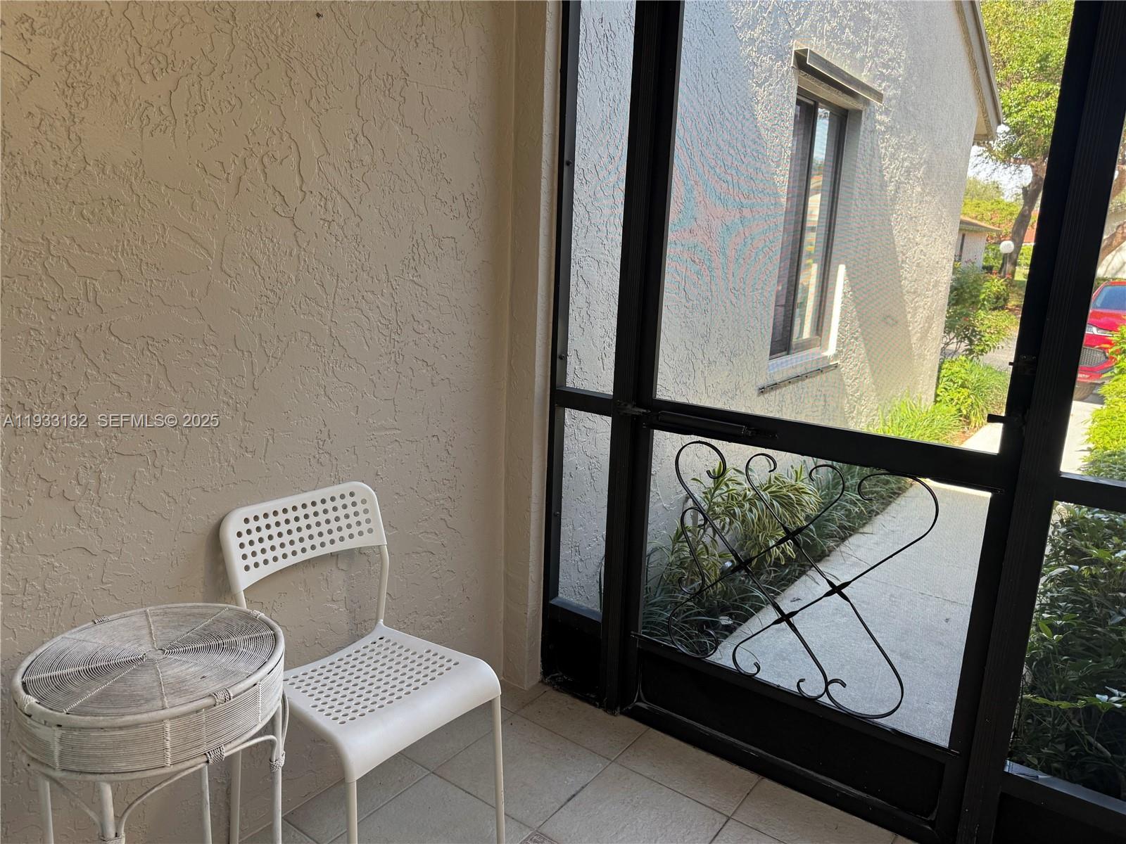 8200 Whispering Palm Drive, Unit F Boca Raton, FL 33496 - Photo 4 of 19 a view of chair and glass window