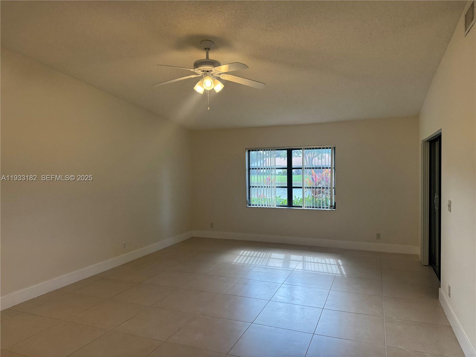 8200 Whispering Palm Drive, Unit F Boca Raton, FL 33496 - Photo 5 of 19 a view of an empty room with a window