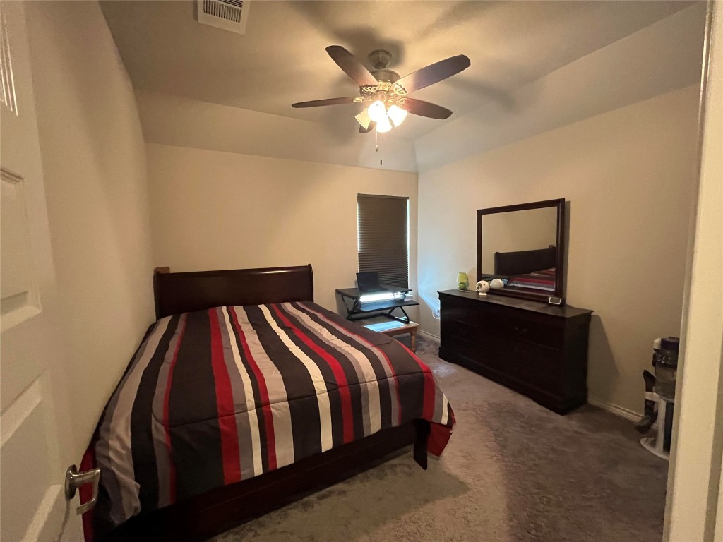 14104 McCoy Loop, Unit 3 Austin, TX 78717 - Photo 11 of 19 a bedroom with a bed and a chandelier
