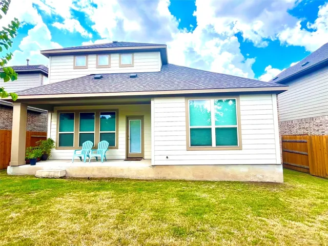 a front view of a house with garden and seating space