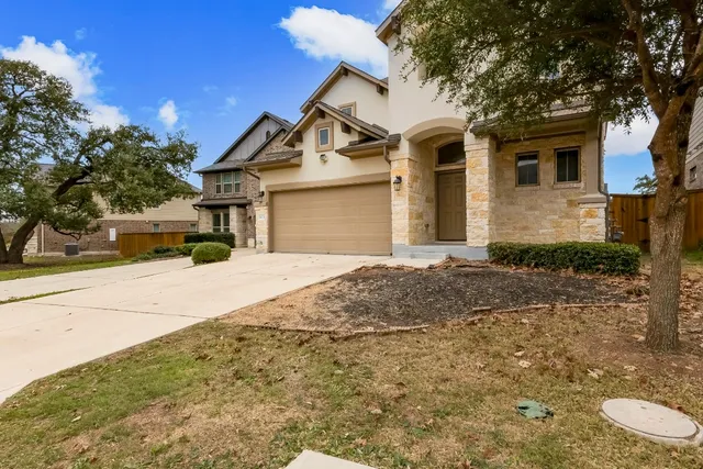 a front view of a house with a yard and garage