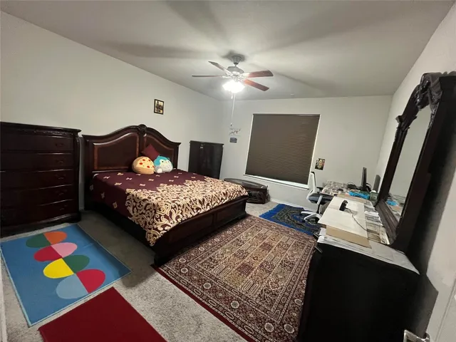 a bedroom with a bed and a dresser