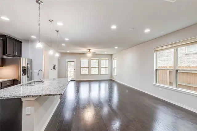 a backyard of a house with lots of green space and outdoor seating