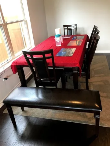 a view of a dining room with furniture and window