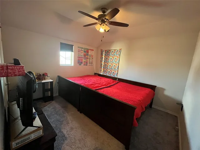a bedroom with a bed and dresser