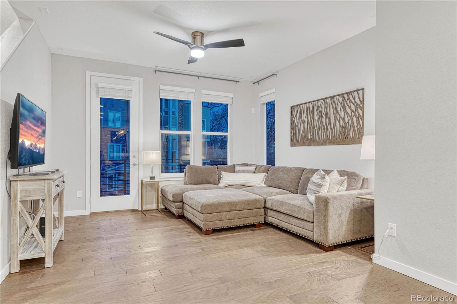 8338 Rivulet Point Highlands Ranch, CO 80129 - Photo 14 of 46 a living room with furniture a flat screen tv and a fireplace