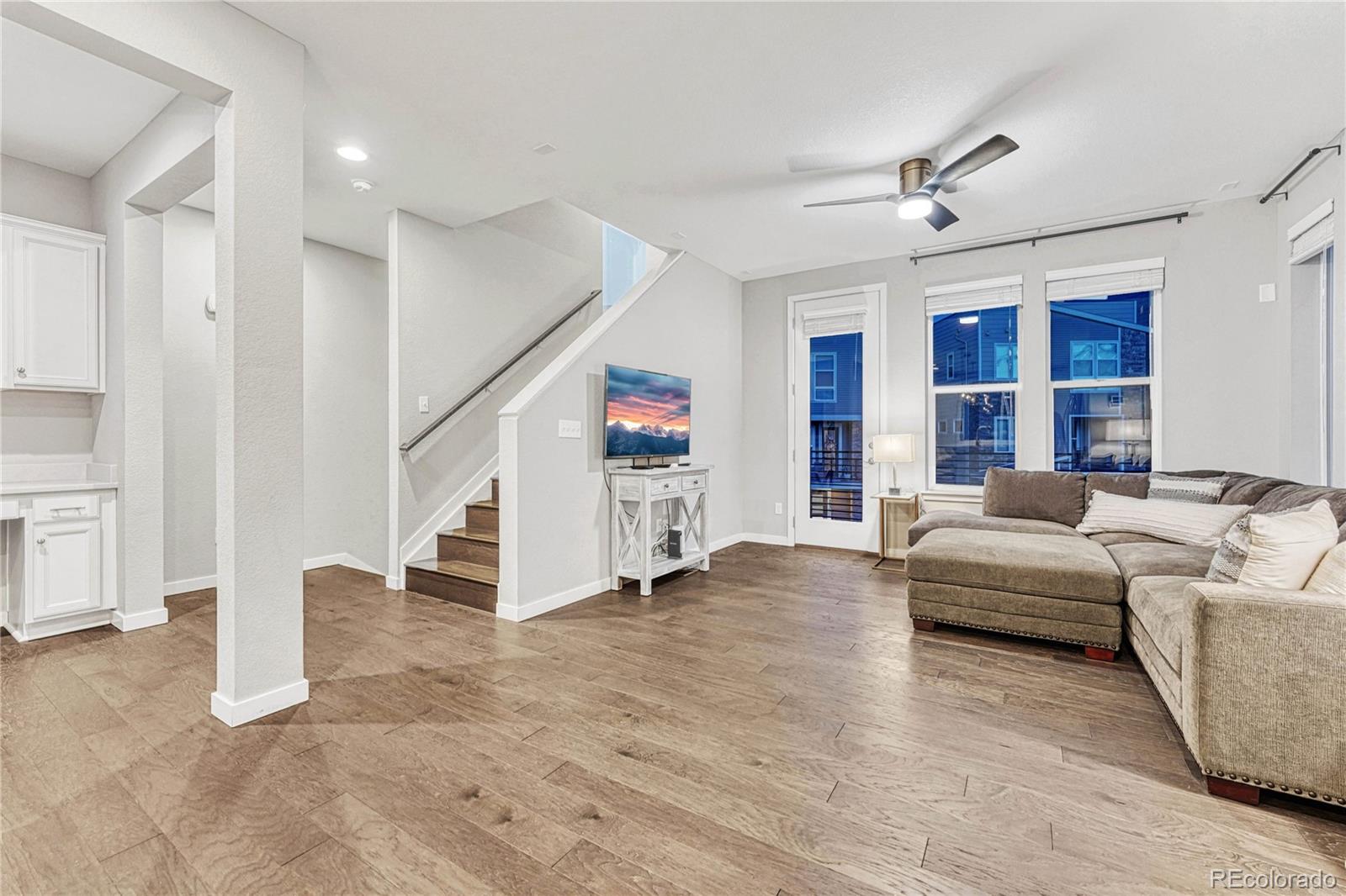 8338 Rivulet Point Highlands Ranch, CO 80129 - Photo 15 of 46 a living room with furniture and a chandelier