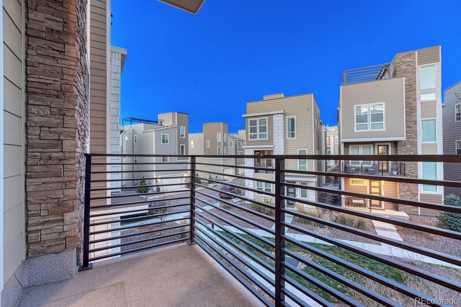 8338 Rivulet Point Highlands Ranch, CO 80129 - Photo 19 of 46 a view of a balcony with two chairs and a gate