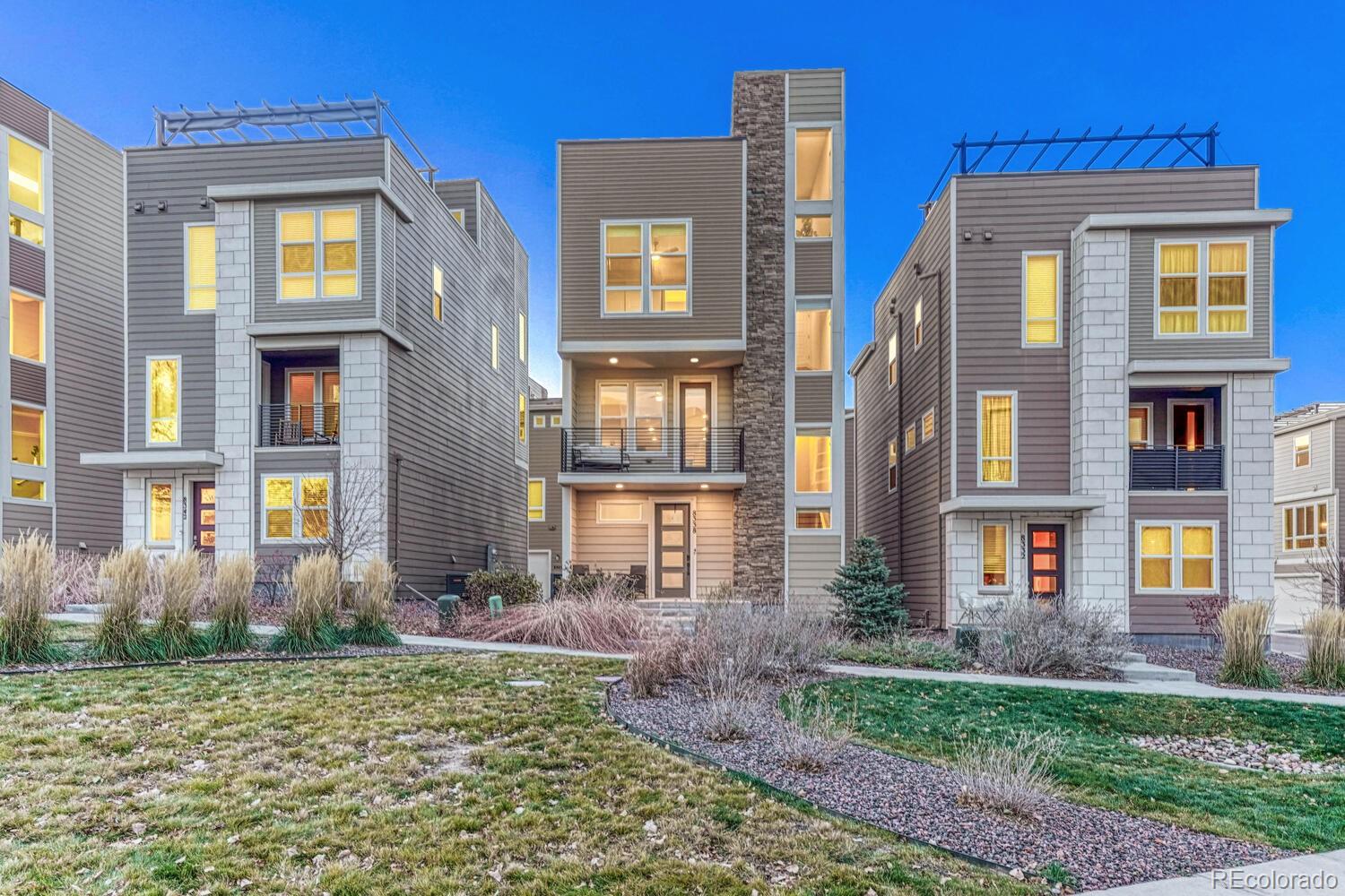 8338 Rivulet Point Highlands Ranch, CO 80129 - Photo 2 of 46 a front view of a residential apartment building with a yard