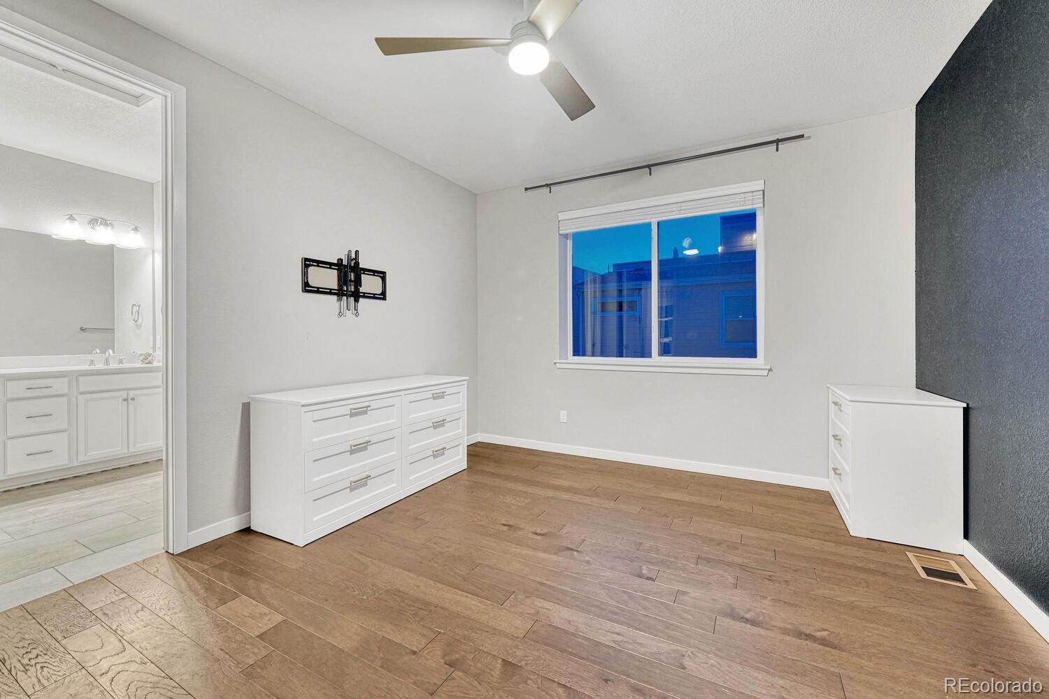 8338 Rivulet Point Highlands Ranch, CO 80129 - Photo 25 of 46 wooden floor and windows in a room