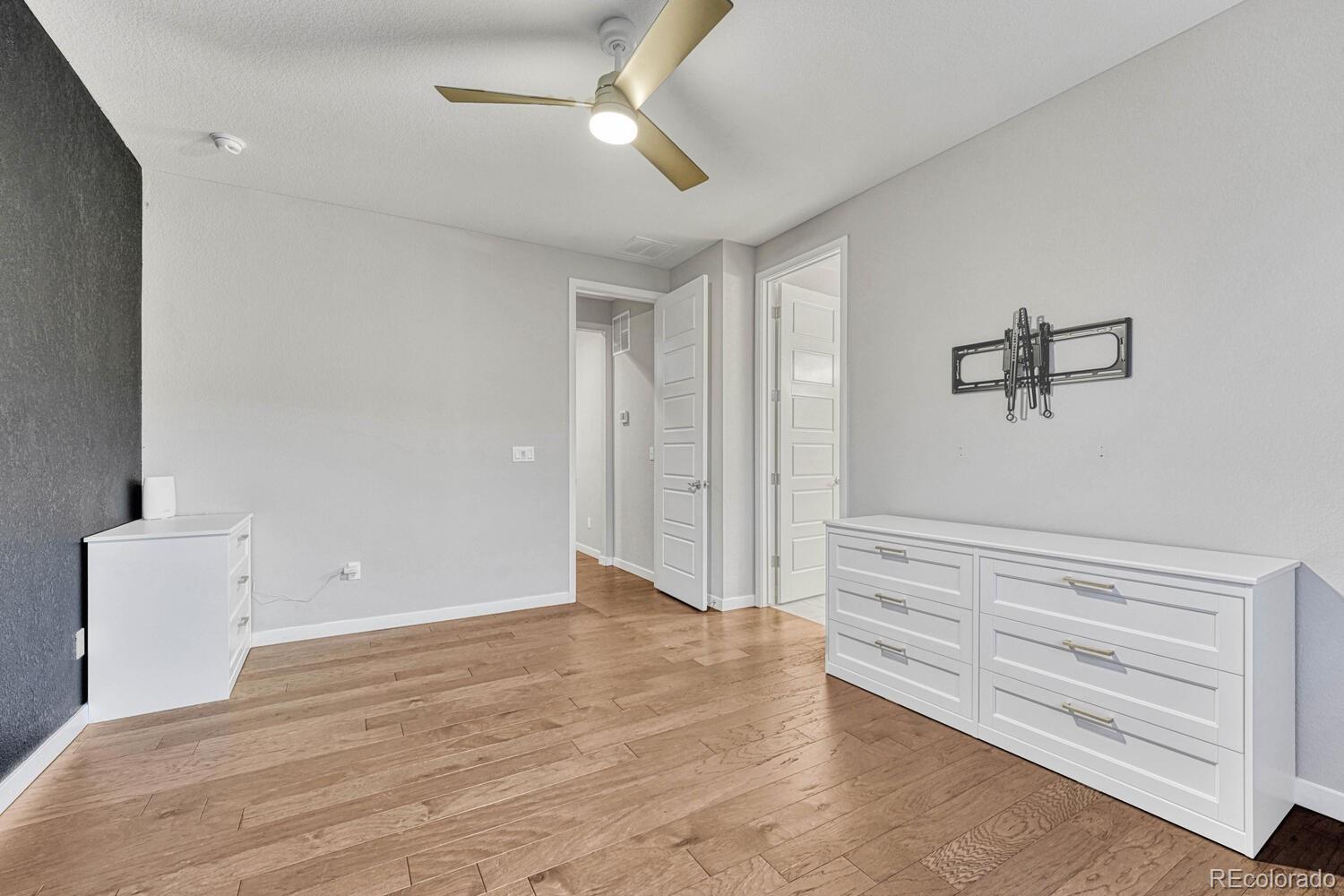 8338 Rivulet Point Highlands Ranch, CO 80129 - Photo 26 of 46 a view of room with stairs and a ceiling fan