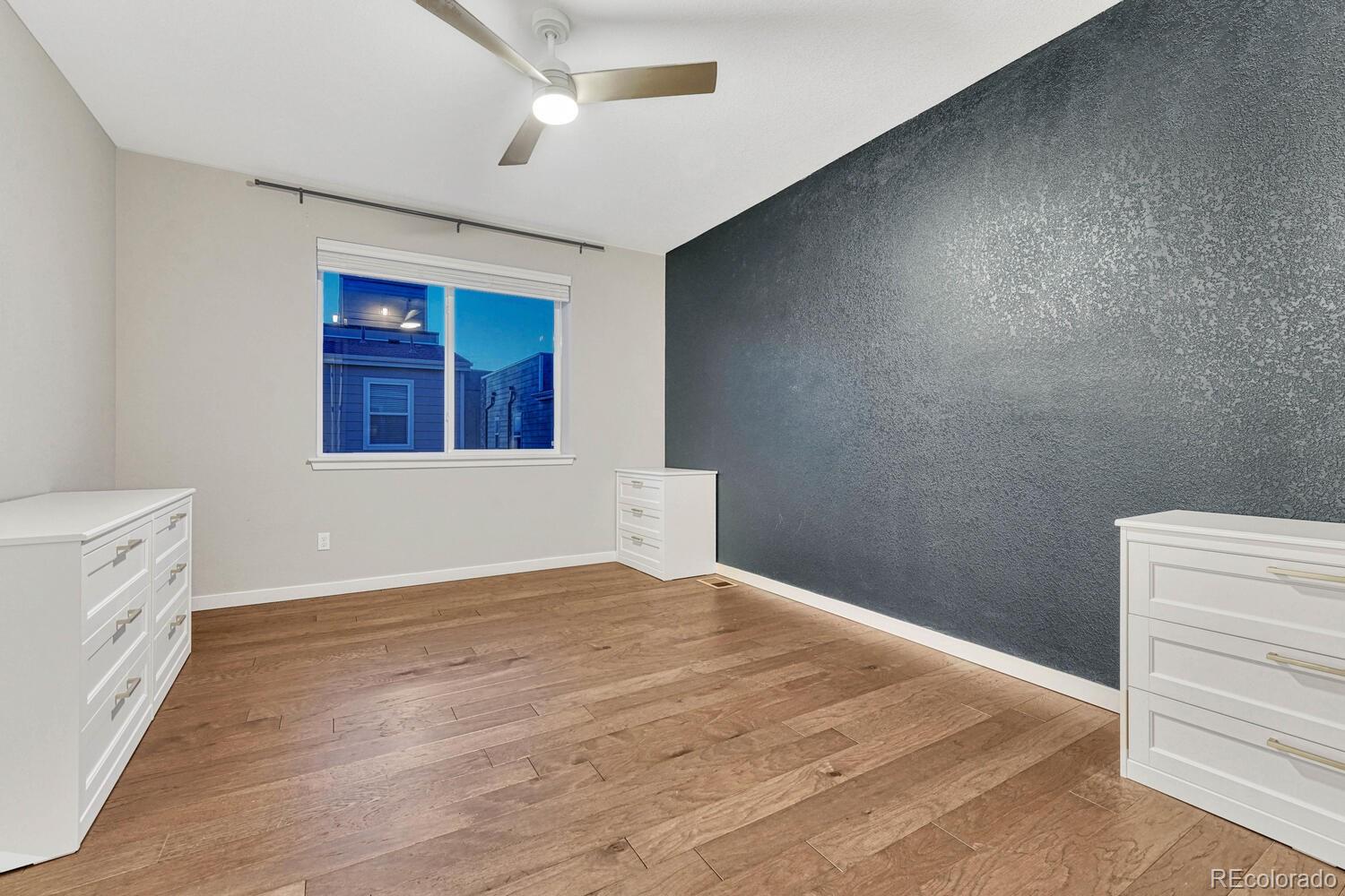 8338 Rivulet Point Highlands Ranch, CO 80129 - Photo 27 of 46 a view of an empty room with wooden floor and a window