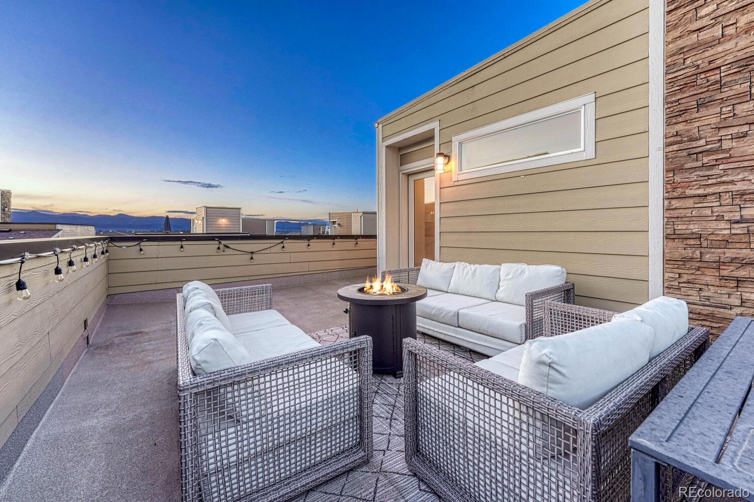 8338 Rivulet Point Highlands Ranch, CO 80129 - Photo 3 of 46 a patio with patio couch and a fireplace