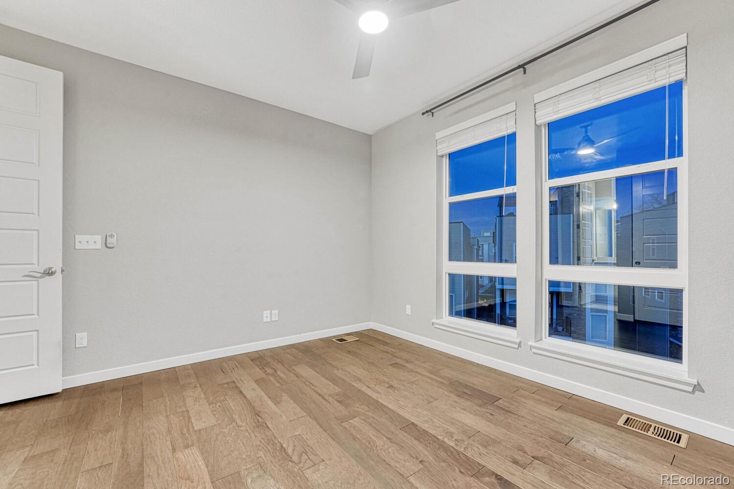 8338 Rivulet Point Highlands Ranch, CO 80129 - Photo 32 of 46 a view of an empty room with wooden floor and a window
