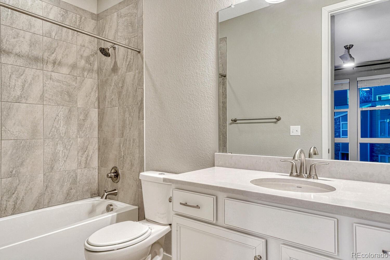 8338 Rivulet Point Highlands Ranch, CO 80129 - Photo 34 of 46 a bathroom with a sink a toilet and shower