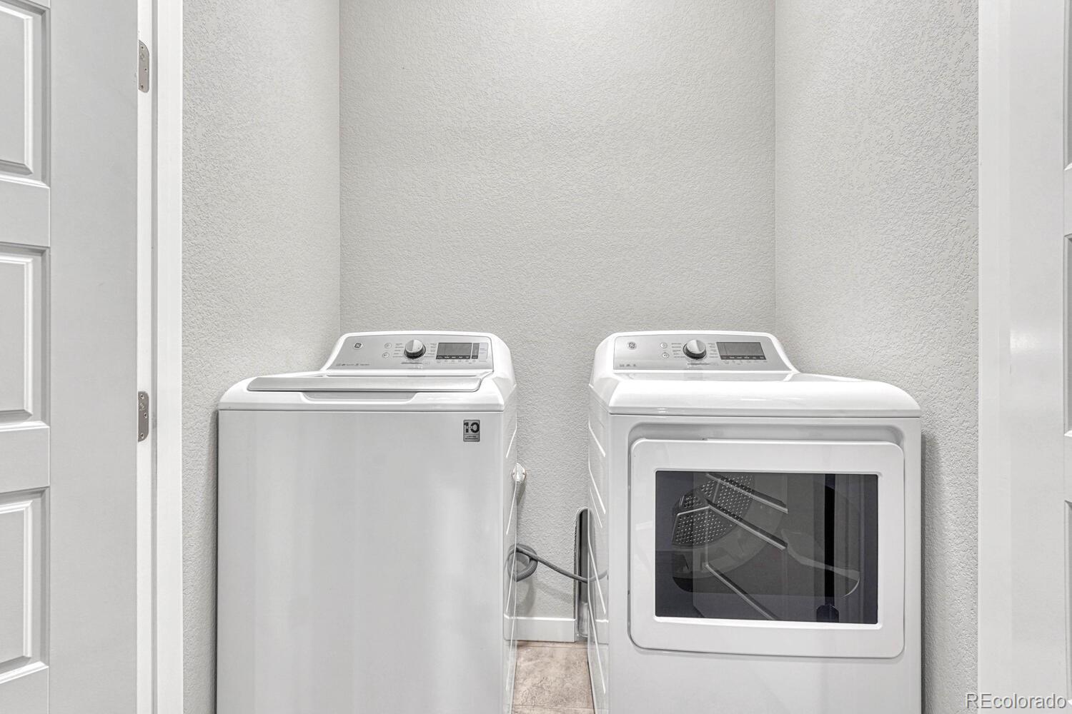8338 Rivulet Point Highlands Ranch, CO 80129 - Photo 35 of 46 a utility room with dryer and washer