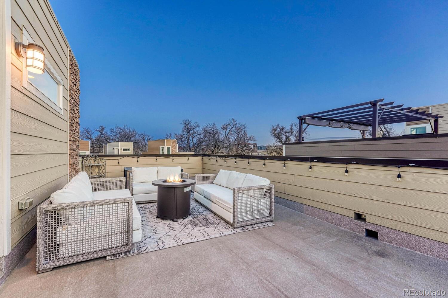 8338 Rivulet Point Highlands Ranch, CO 80129 - Photo 38 of 46 a view of roof deck with couches and potted plants