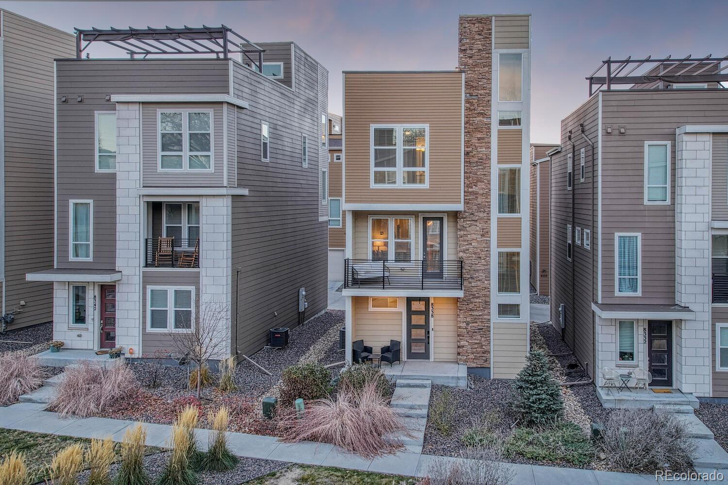 8338 Rivulet Point Highlands Ranch, CO 80129 - Photo 44 of 46 a front view of a residential apartment building with a yard