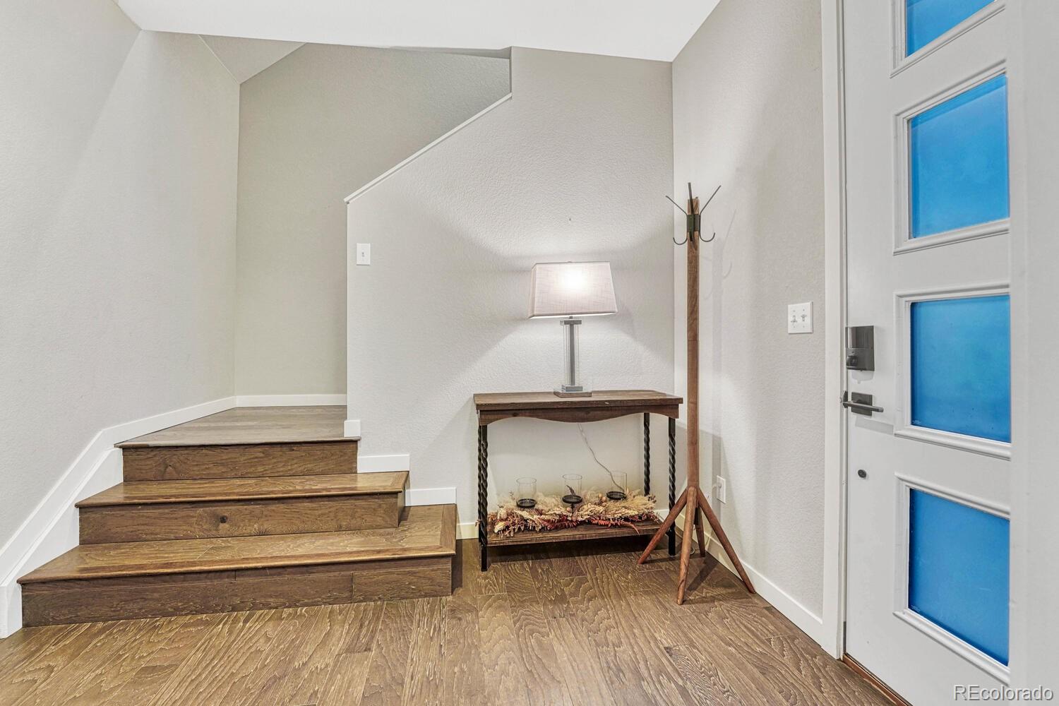 8338 Rivulet Point Highlands Ranch, CO 80129 - Photo 7 of 46 a bedroom with a bed and a lamp