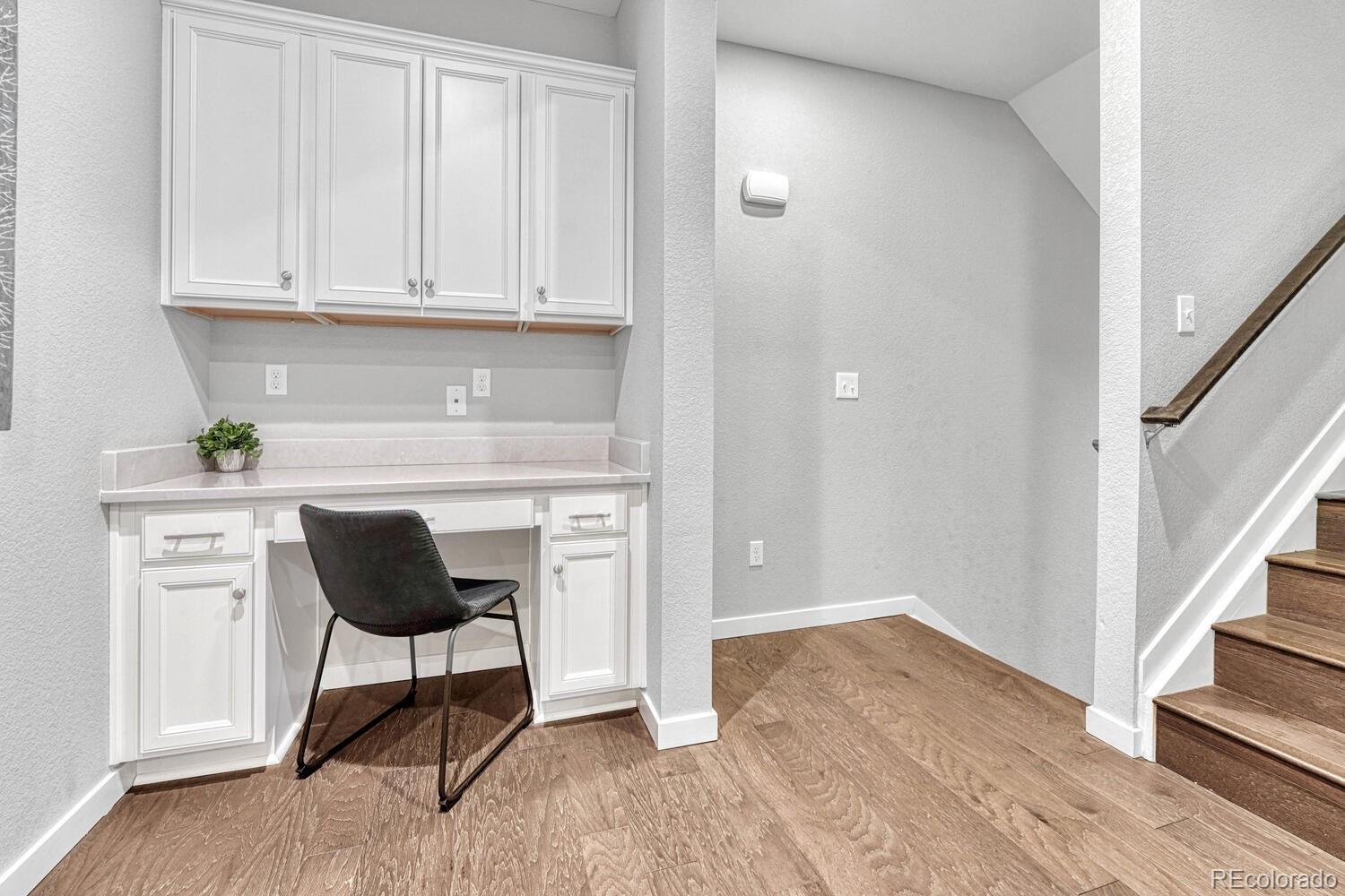 8338 Rivulet Point Highlands Ranch, CO 80129 - Photo 9 of 46 a kitchen with a chair and cabinets