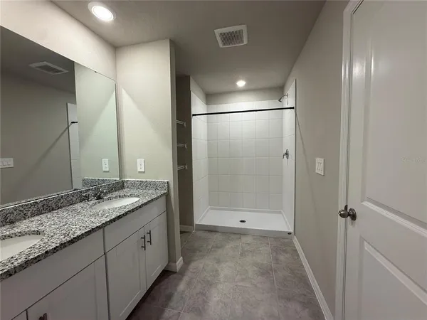 a bathroom with a granite countertop sink mirror and double