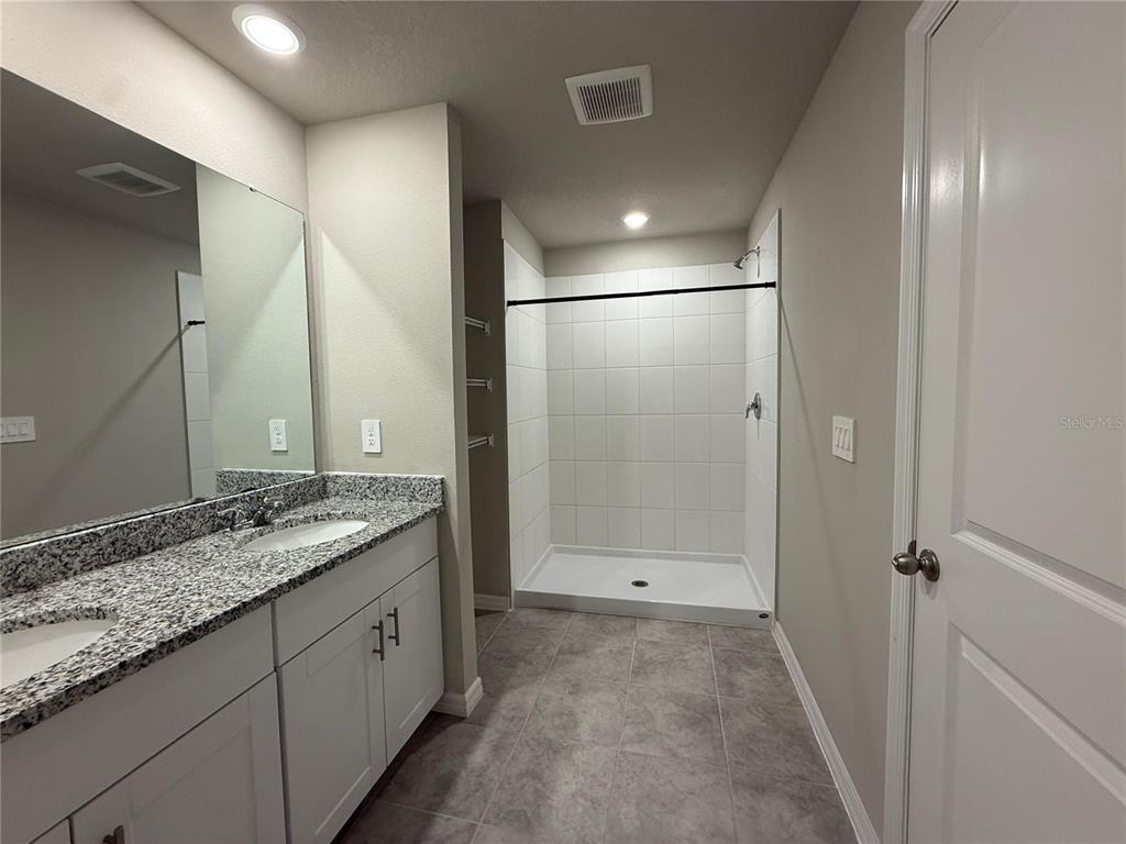 7649 Intrepid Road Wesley Chapel, FL 33545 - Photo 12 of 46 a bathroom with a granite countertop sink mirror and double