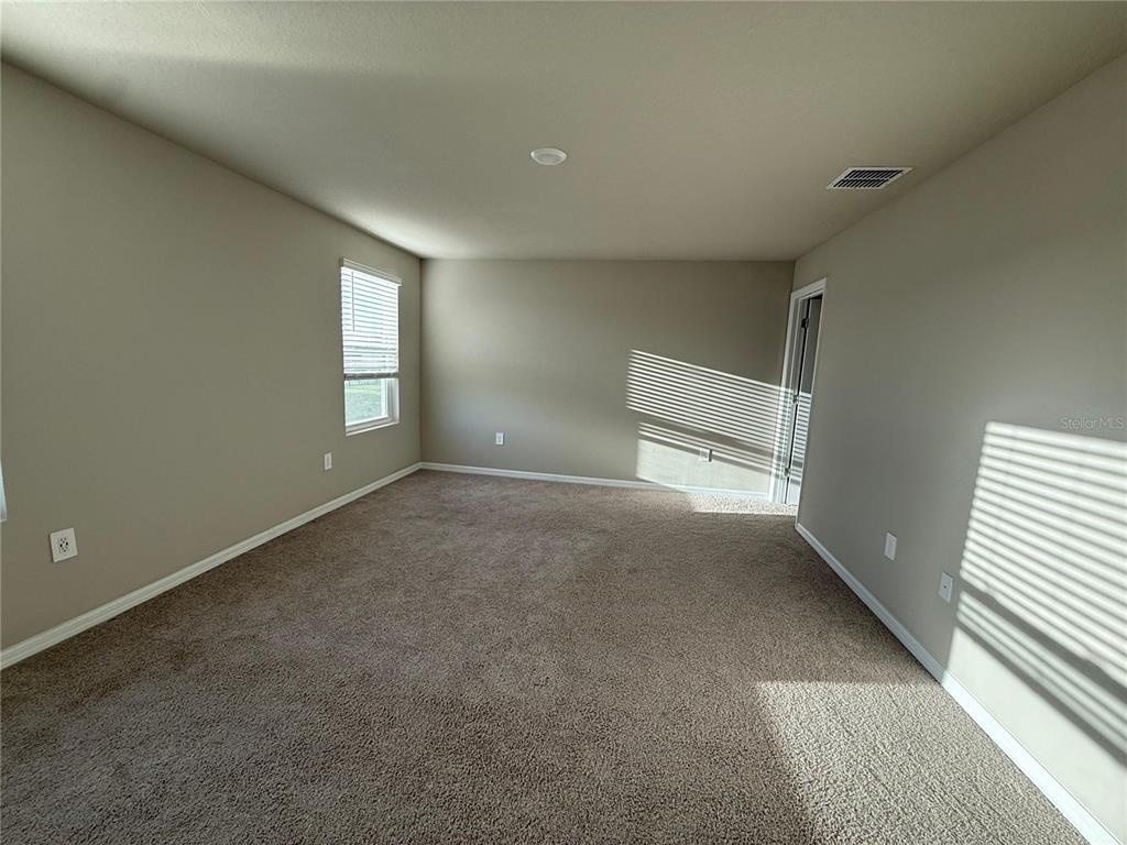 7649 Intrepid Road Wesley Chapel, FL 33545 - Photo 13 of 46 an empty room with windows