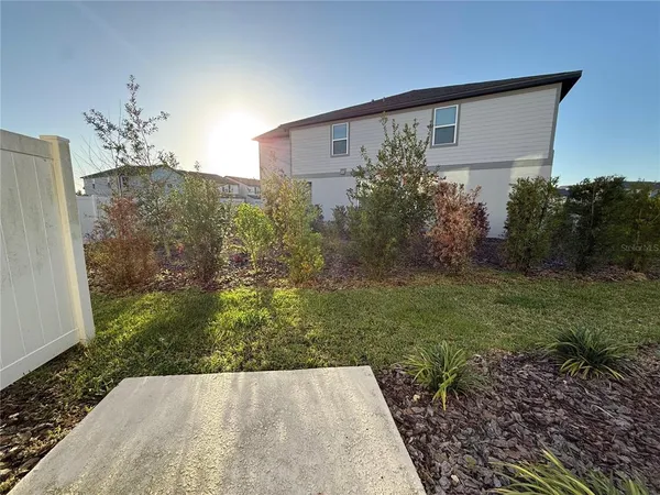 a view of a house with a backyard
