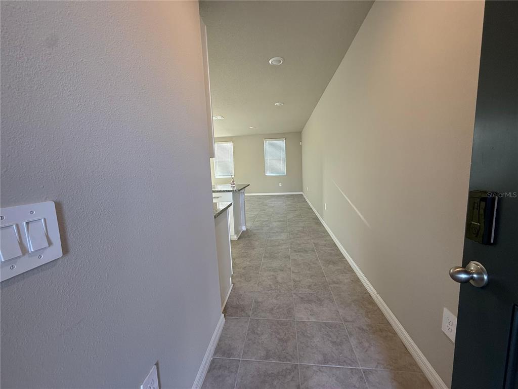 7649 Intrepid Road Wesley Chapel, FL 33545 - Photo 28 of 46 a view of a hallway with wooden floor and a bathroom