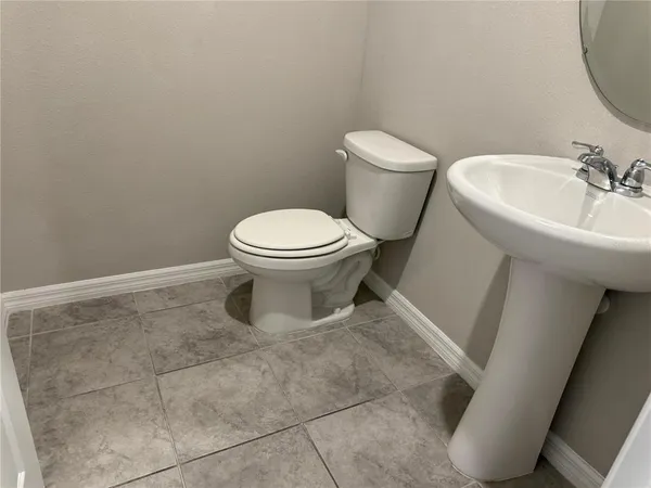 a white toilet sitting next to a bathroom sink
