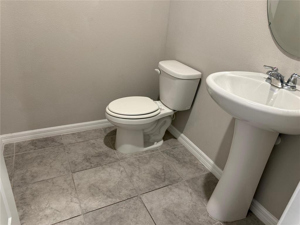 7649 Intrepid Road Wesley Chapel, FL 33545 - Photo 6 of 46 a white toilet sitting next to a bathroom sink