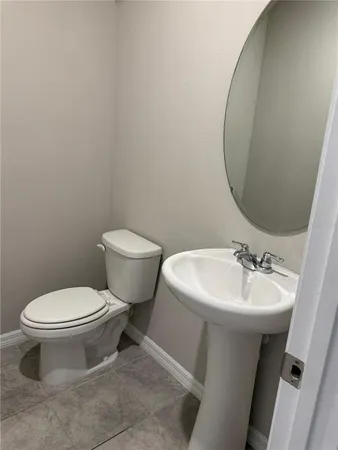 a bathroom with a sink toilet and a mirror